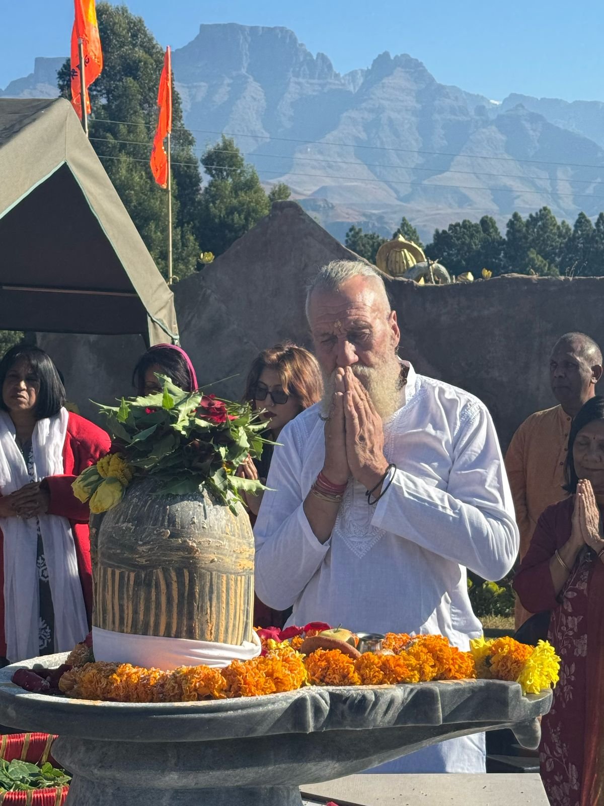 CJ Hood, hands folded in prayer at Shiva Kshetra