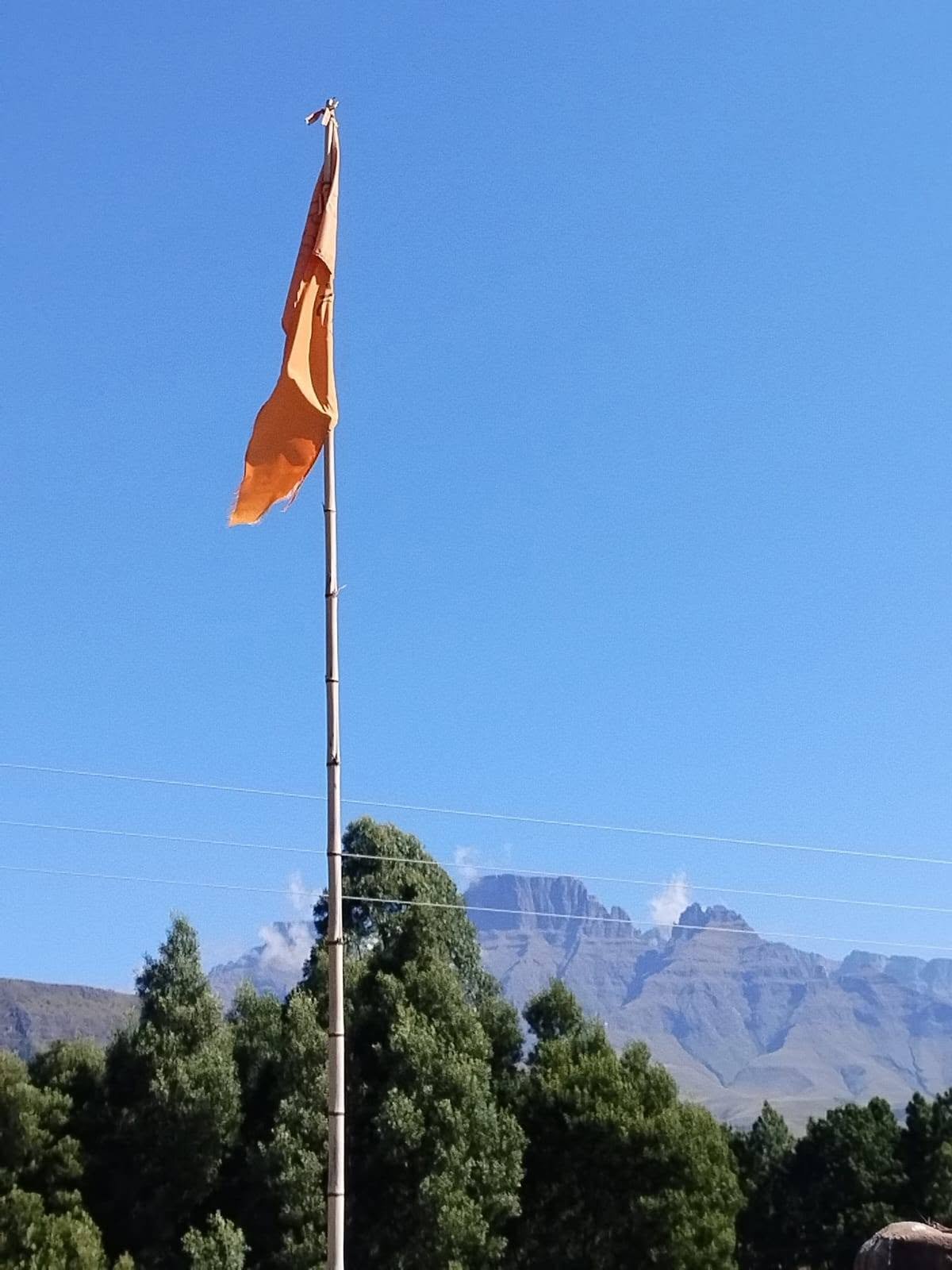 Orange prayer flag with mountain backdrop
