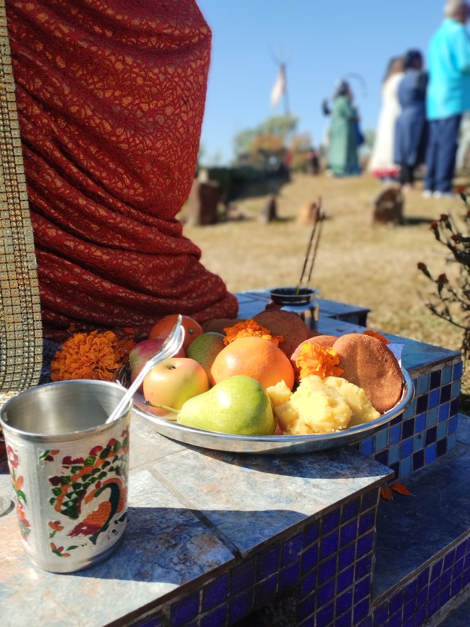 Plate of fruit and sweets offered before the murtis
