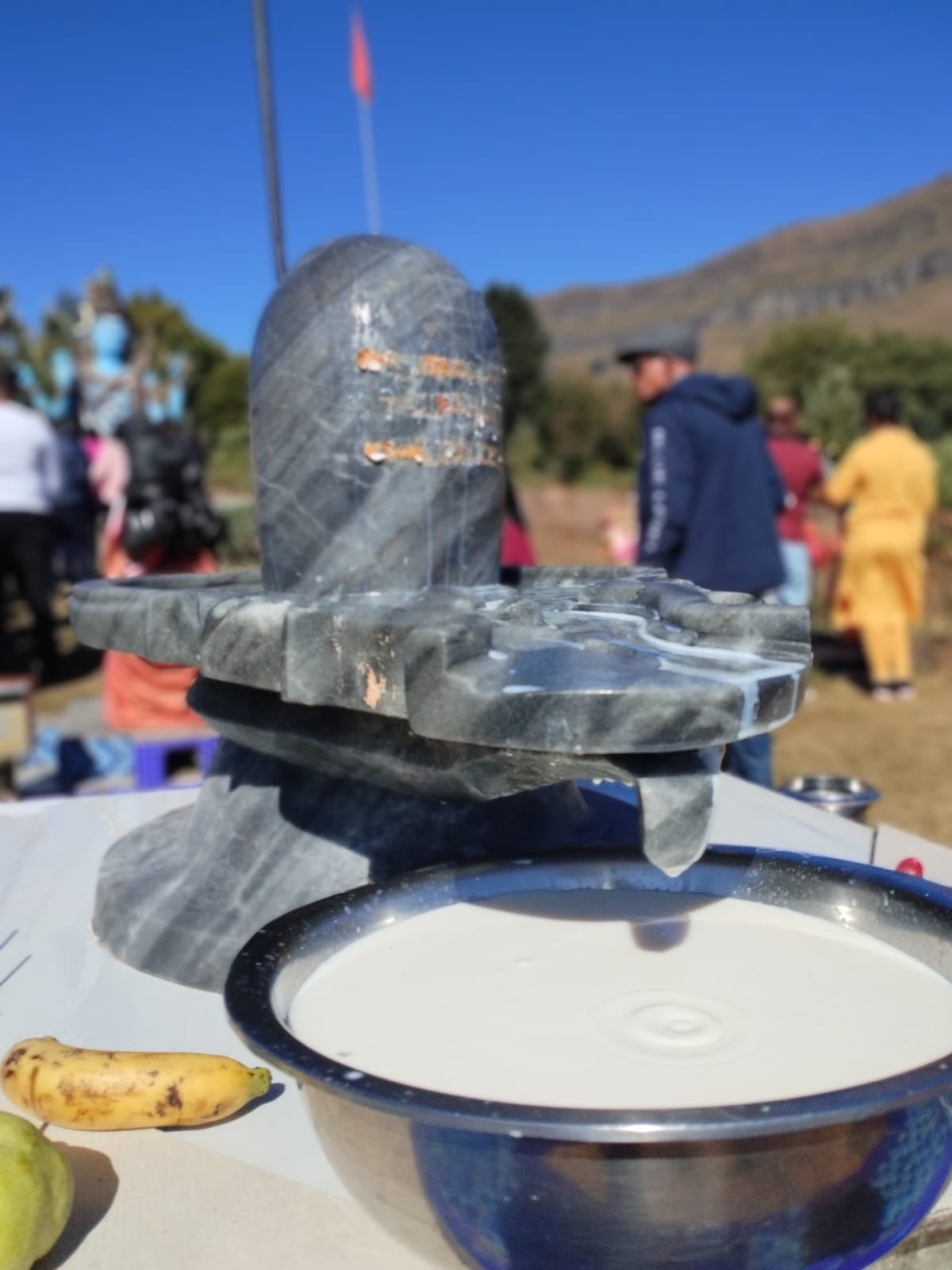 Close-up of milk being poured over the Shiva lingam