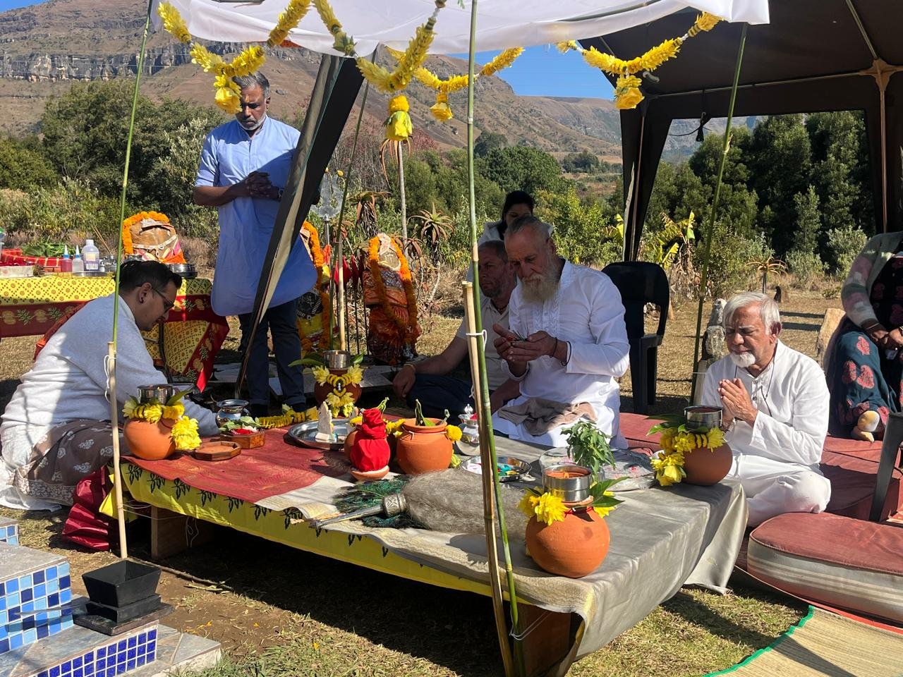 Priests conducting a puja ceremony under the tent