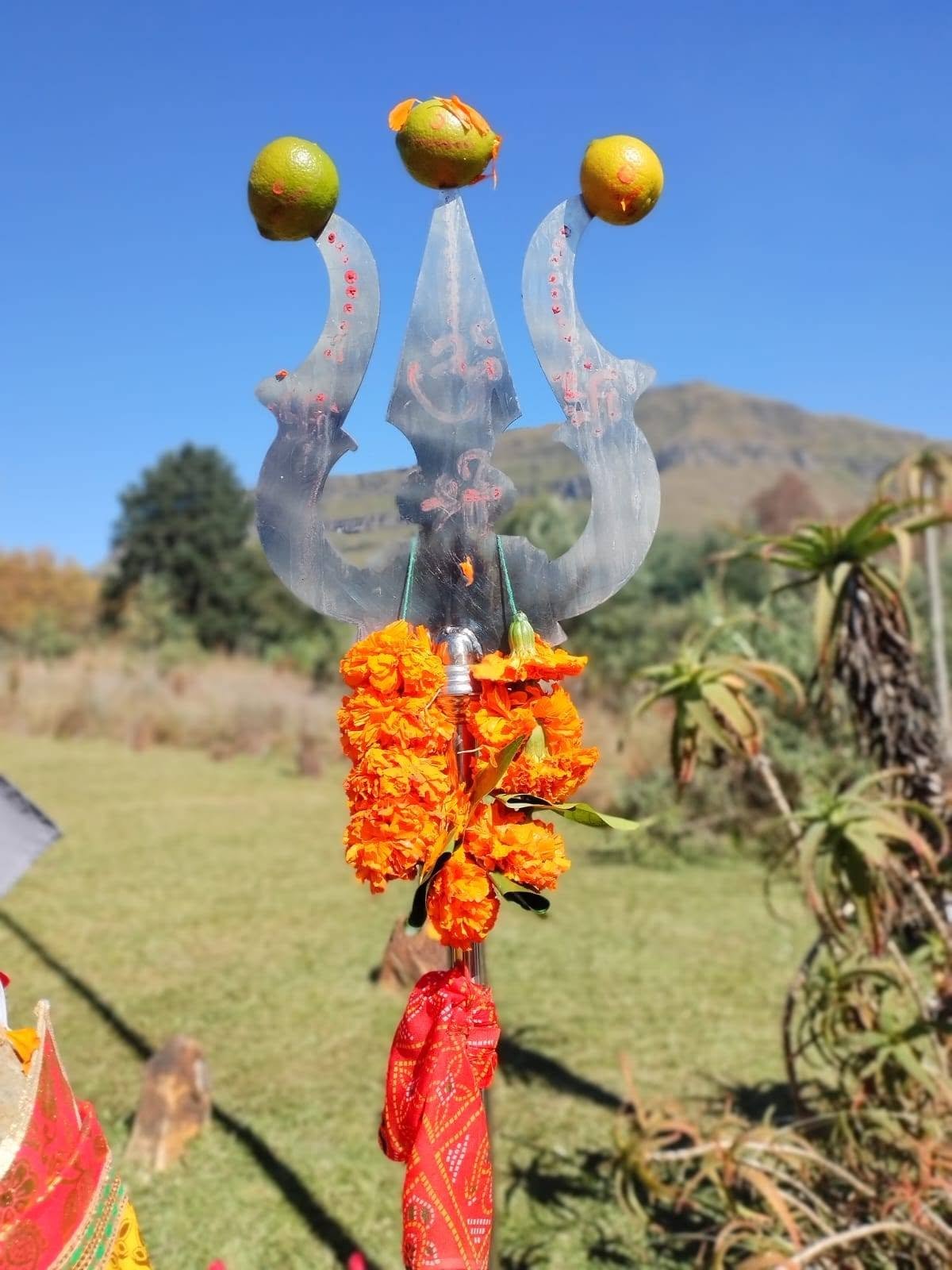 Trident with fruit offerings